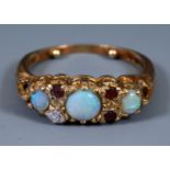 A 9ct gold ruby and opal ring, ring size O