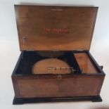 An Imperial Polyphon, in a walnut case, 60 cm wide, with a winder and thirty eight discs in an