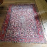 A Heriz cream ground carpet, main red border with repeating geometric forms, centre with cream