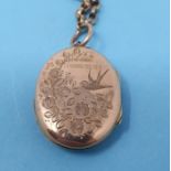 A 9ct gold oval locket, engraved with swallow and flowers, on a yellow metal chain, an oval cameo