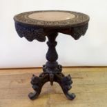 An early 20th century Burmese tripod table, 56 cm diameter