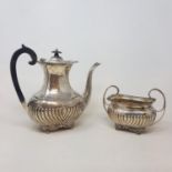 A silver coffee pot, with a reeded lower body, and a matching two handle sugar bowl, London 1906,