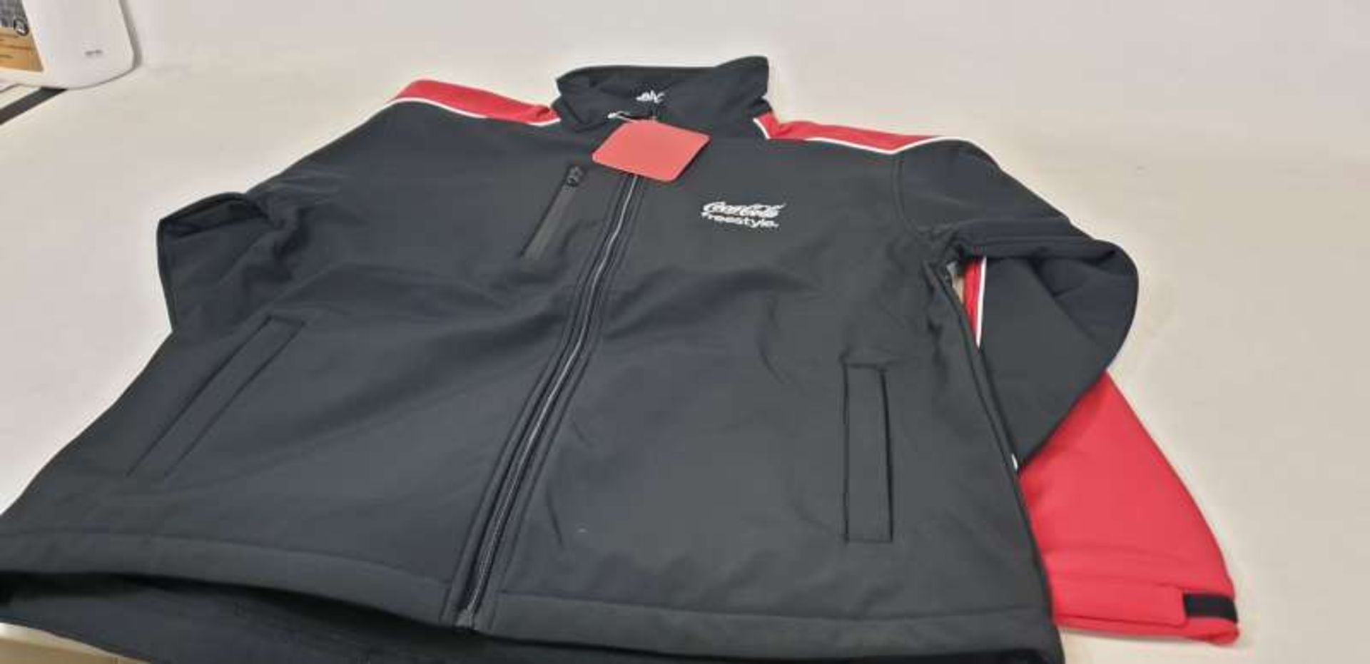 56 X COCA COLA FREESTYLE JACKETS IN VARIOUS SIZES