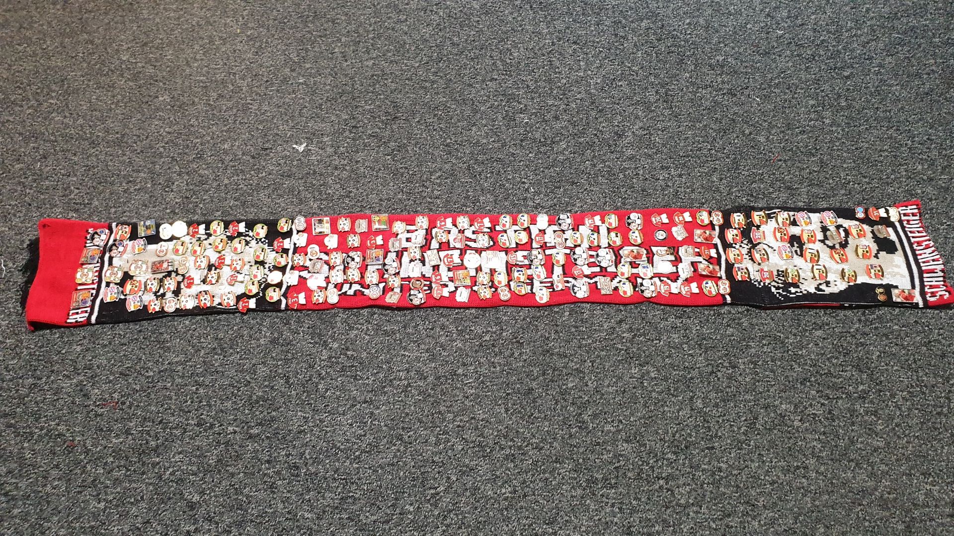 MANCHESTER UNITED SCARF CONTAINING APPROX 190 X PIN BADGES IE MANCHESTER IS RED, UNITED V LIVERPOOL,