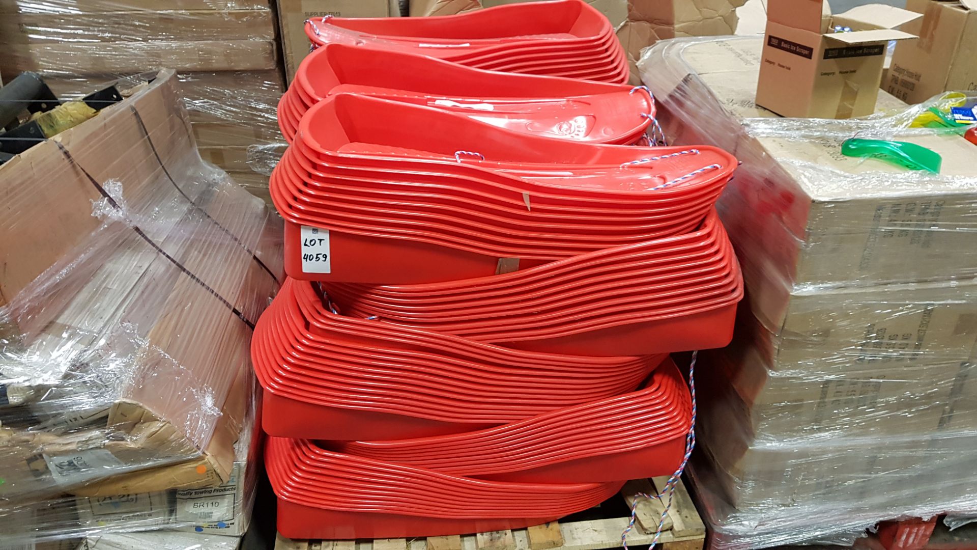 APPROX 150 X BRAND NEW RED PLASTIC SLEDGES WITH PULL ROPE ATTACHED