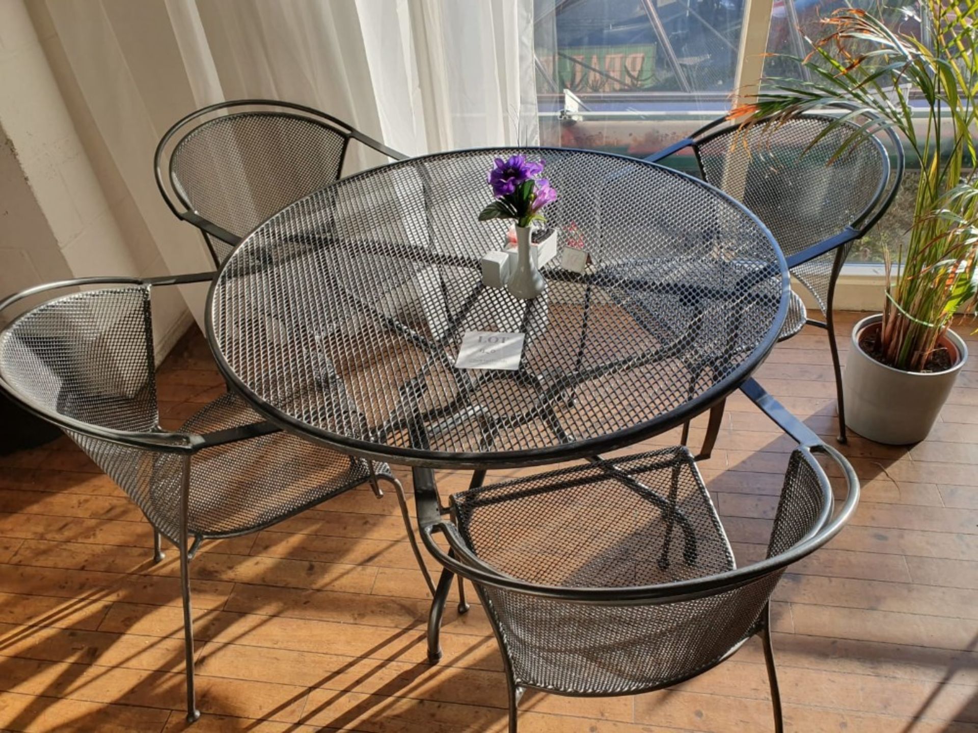 Circular metal table 1,050mm diameter with 4 metal chairs, salt and pepper pots, sugar jar and