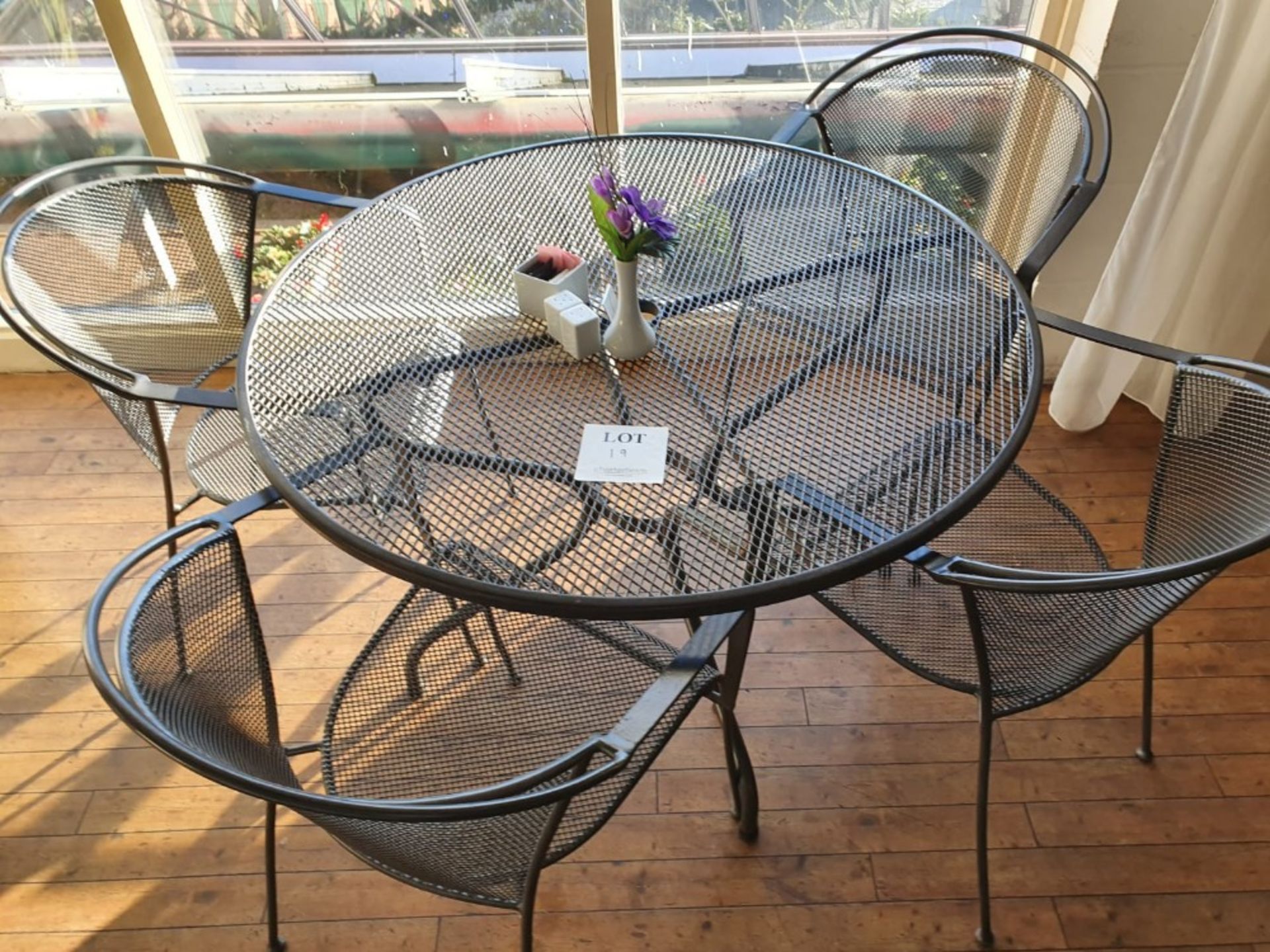 Circular metal table 1,050mm diameter with 4 metal chairs, salt and pepper pots, sugar jar and