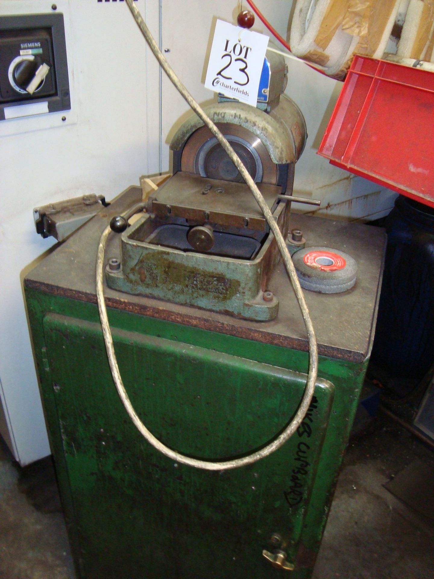 A Dewhurst cabinet mounted diamond tool grinding wheel