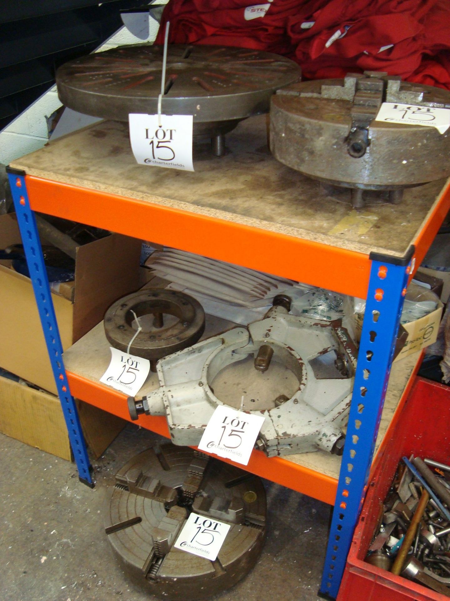 Two lathe chucks, a circular surface plate and a lathe bar centre, as lotted