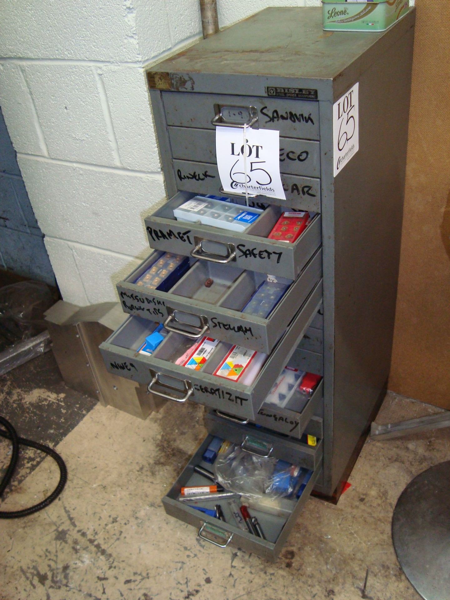 A steel multi drawer cabinet containing various cutting tool inserts, as lotted