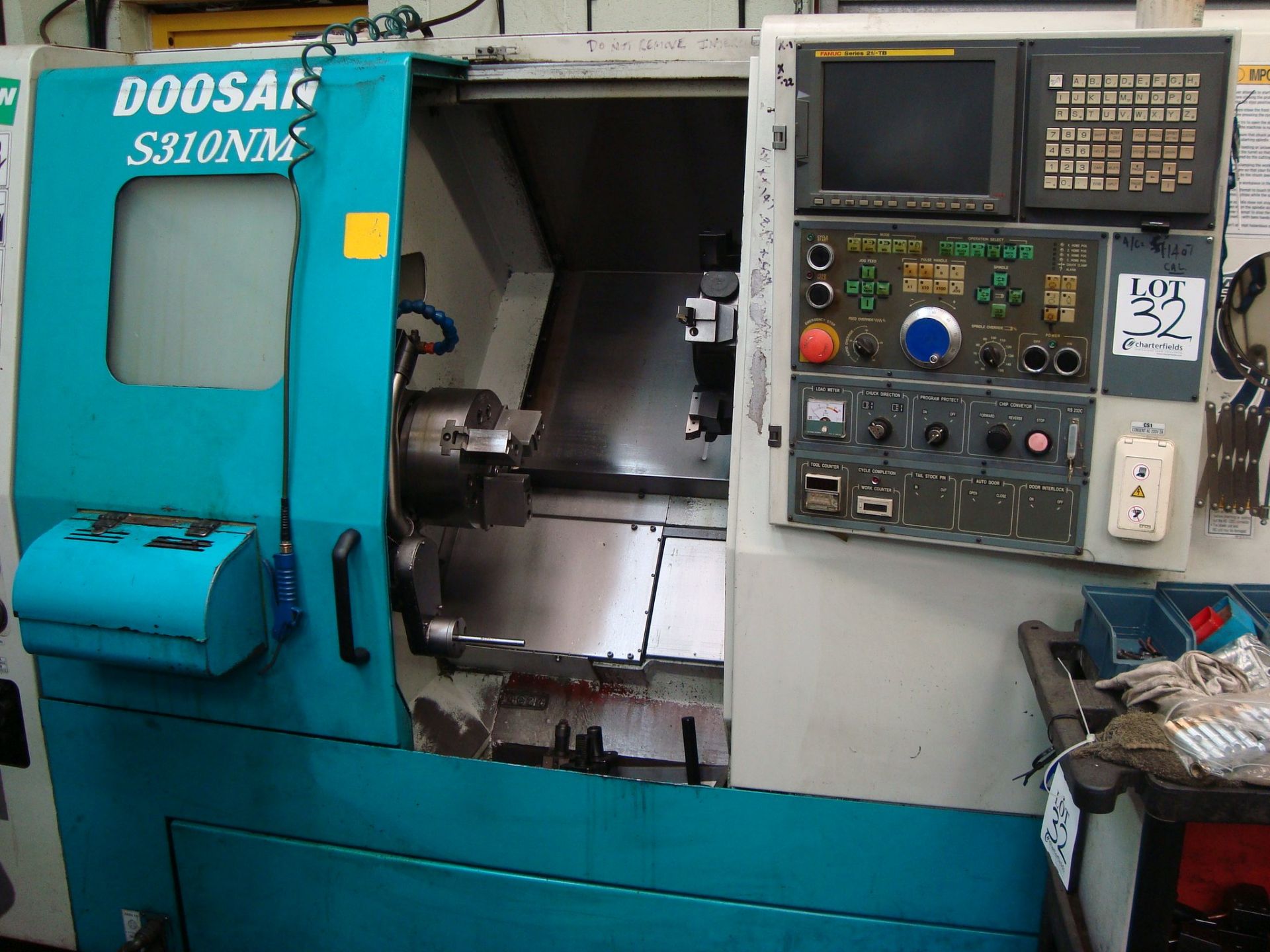 A Doosan S310NM CNC turning centre Serial number LSC1005 with Fanuc Series 21i-TB control, swarf