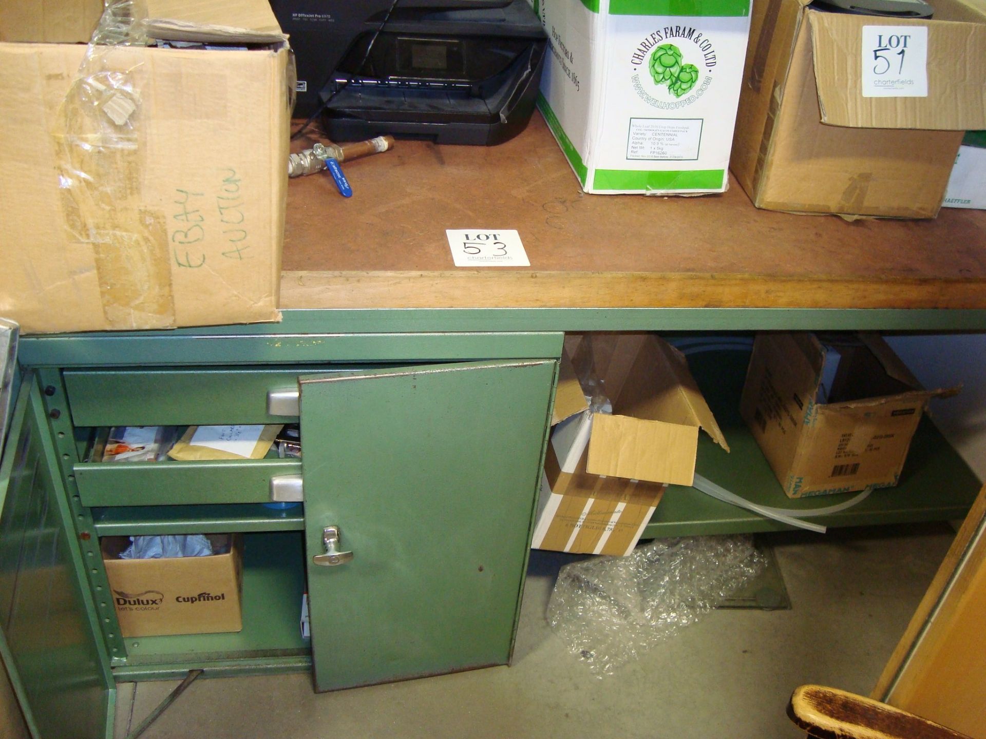 A steel framed work bench with cupboard under