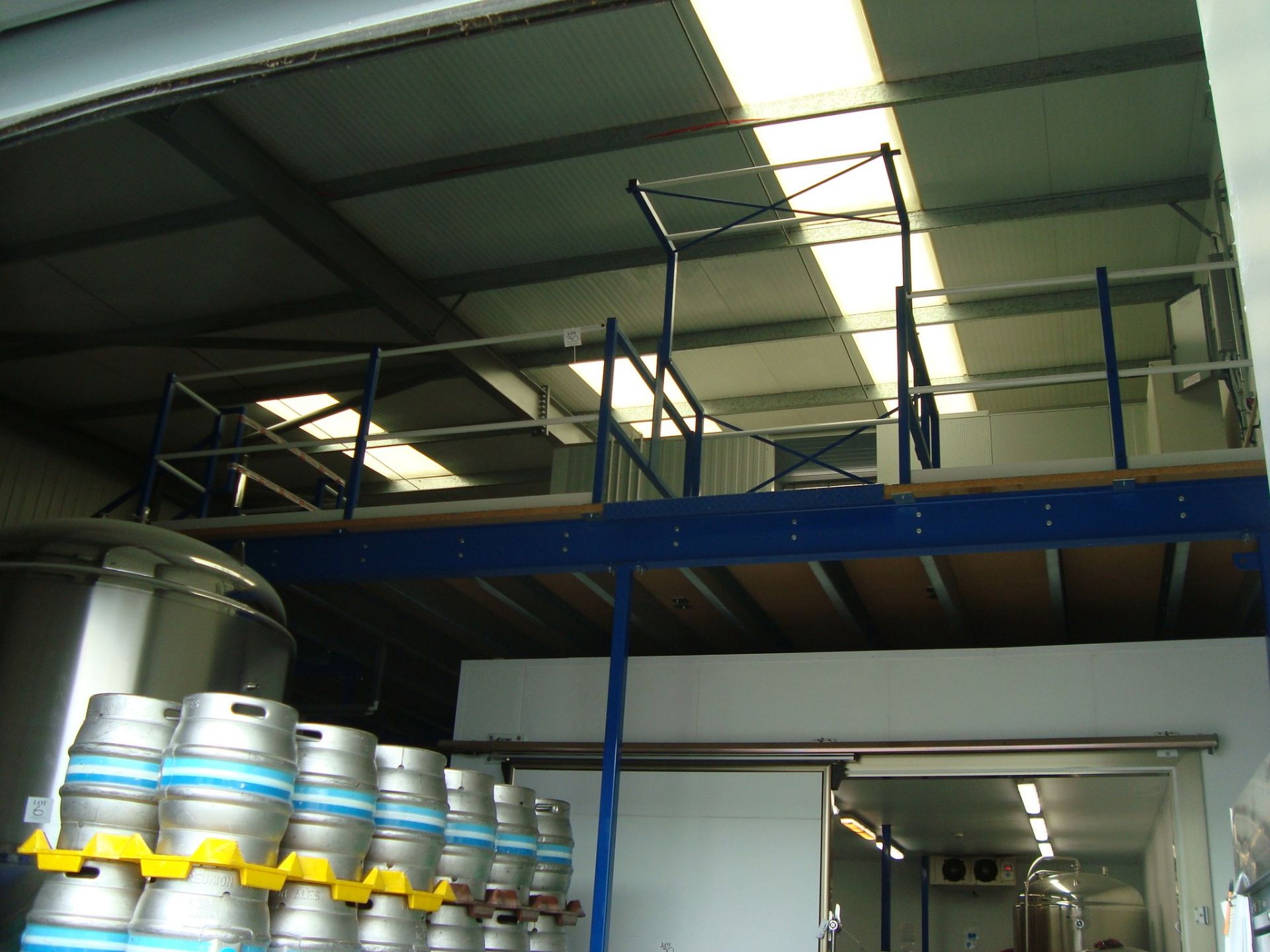 A steel framed mezzanine floor structure, approximately 13x7m, with two insulated cold room