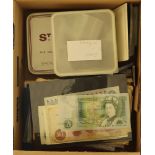 FEATURED LOT COINS AND BANKNOTES An assembly with tins and packets of miscellaneous British and