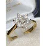 9 carat gold diamond Daisy ring approximately 0.5 carats of diamonds