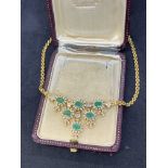 18 carat gold necklace set with emeralds and baguette diamonds weighs 32 g