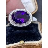 18 carat gold ring set with approximately 6 carat amethyst with diamonds approximately 9 g