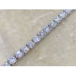 18 carat gold diamond tennis bracelet set with approximately four carats of diamonds