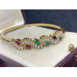 18 carat gold bangle set with rubies emeralds sapphire and diamonds H/I colour VS/SI clarity