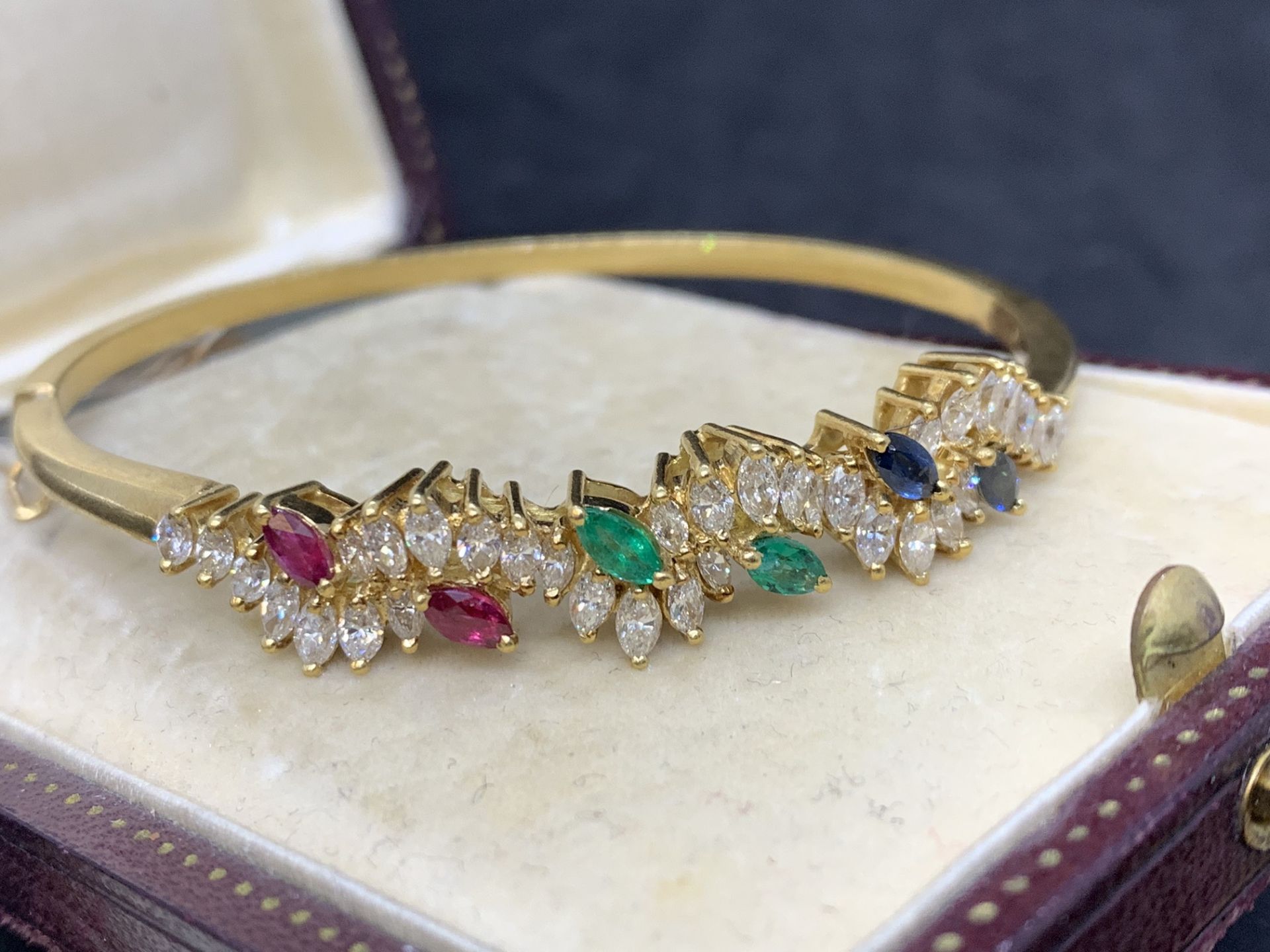 18 carat gold bangle set with rubies emeralds sapphire and diamonds H/I colour VS/SI clarity