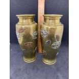 Pair of brass vases patterned with silver coloured and bronze coloured flowers and leaves