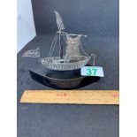 Small silver boat ship mounted on wooden base