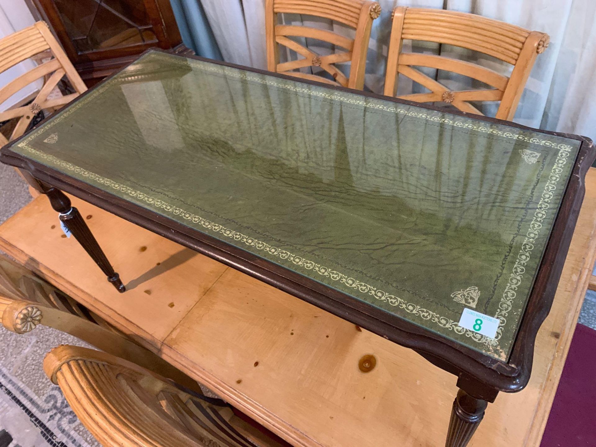 Small occasional table with leather insert with a glass on top