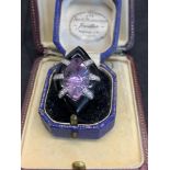 Amethyst diamond and Alex are room in white metal tested as 18 carat gold approximately the size and