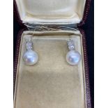 Princess cut diamond and pearl earrings set in white metal tested as 18ct white gold