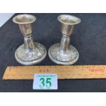 Pair of small white metal candle sticks with international silver hallmark