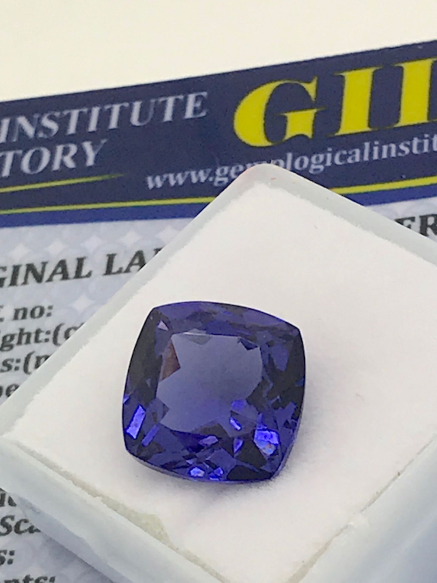 BLUE STONE WITH CARD MARKED TANZANITE