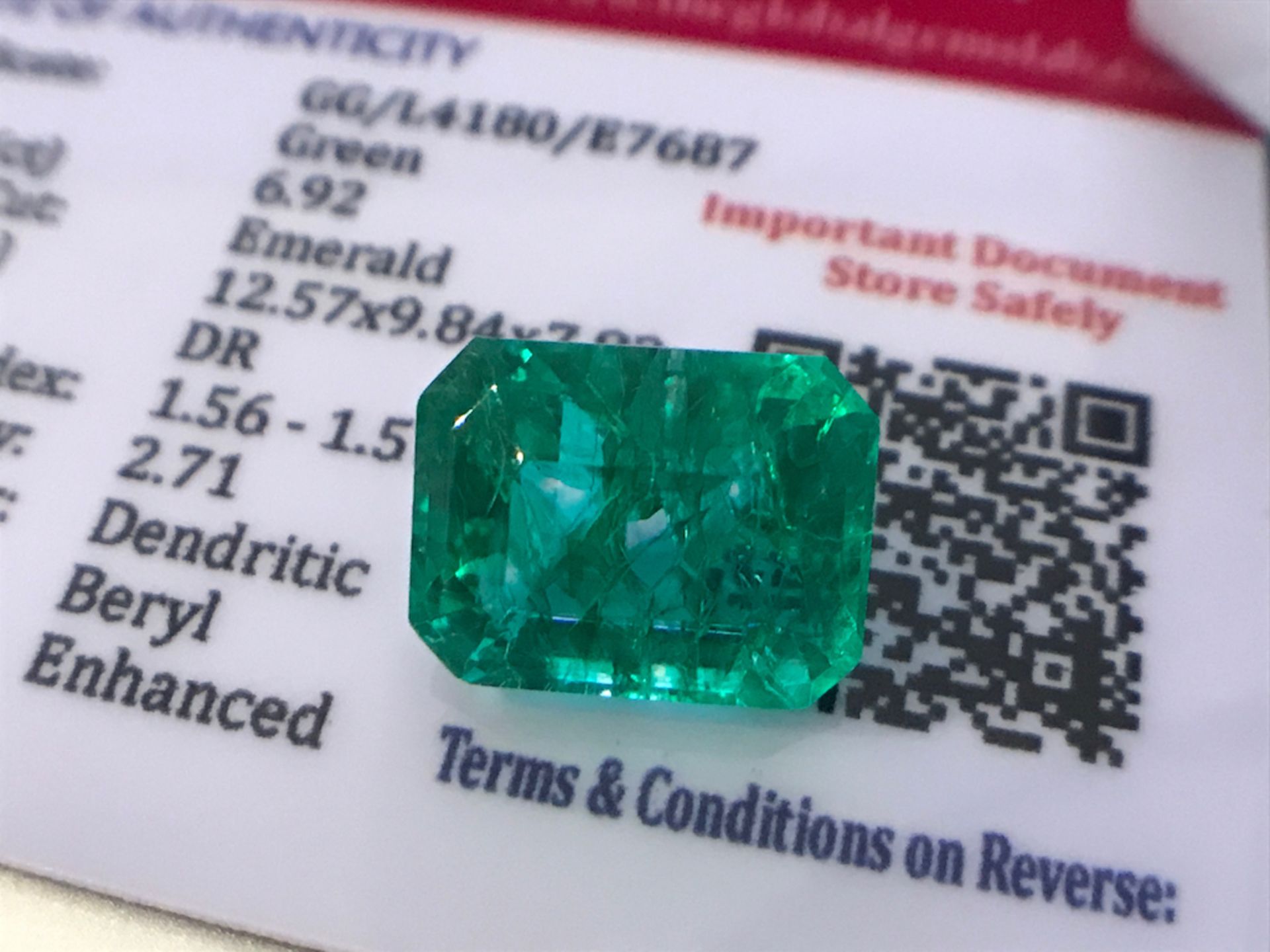 GREEN STONE WITH CARD MARKED EMERALD