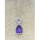 18ct GOLD AMETHYST & DIAMOND PENDANT WITH A 9ct GOLD CHAIN