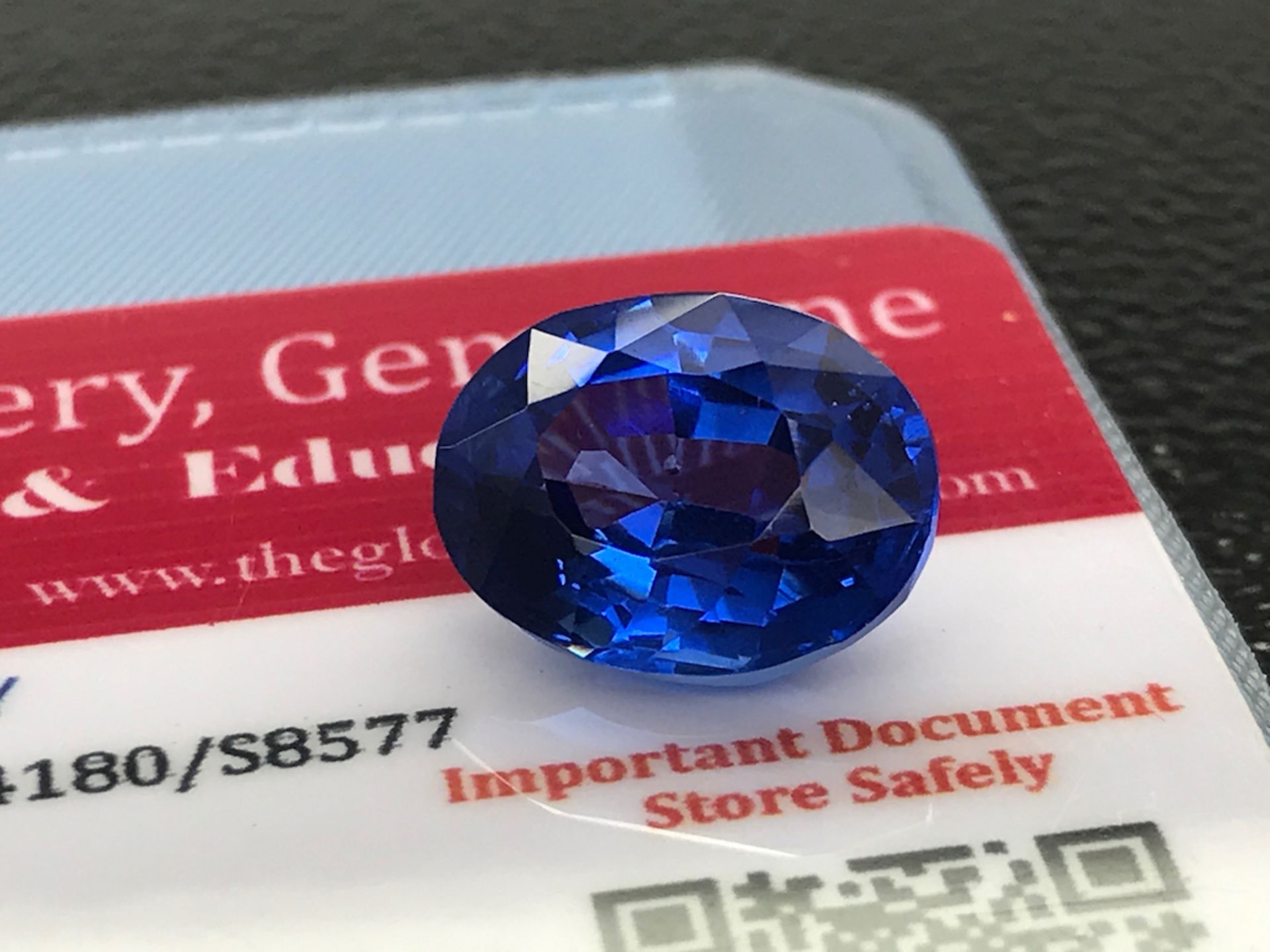 BLUE STONE WITH CARD MARKED SAPPHIRE