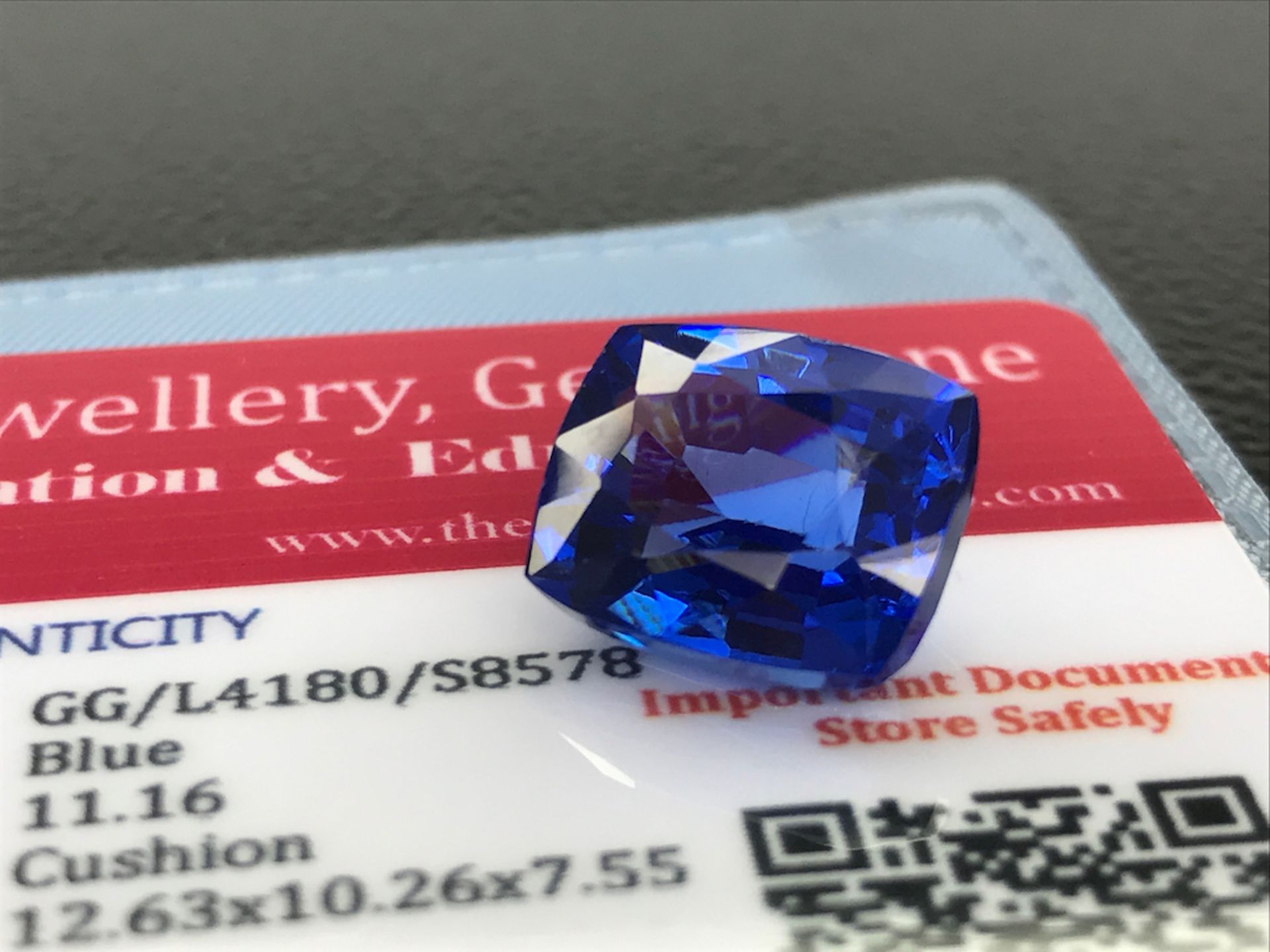 BLUE STONE WITH CARD MARKED SAPPHIRE