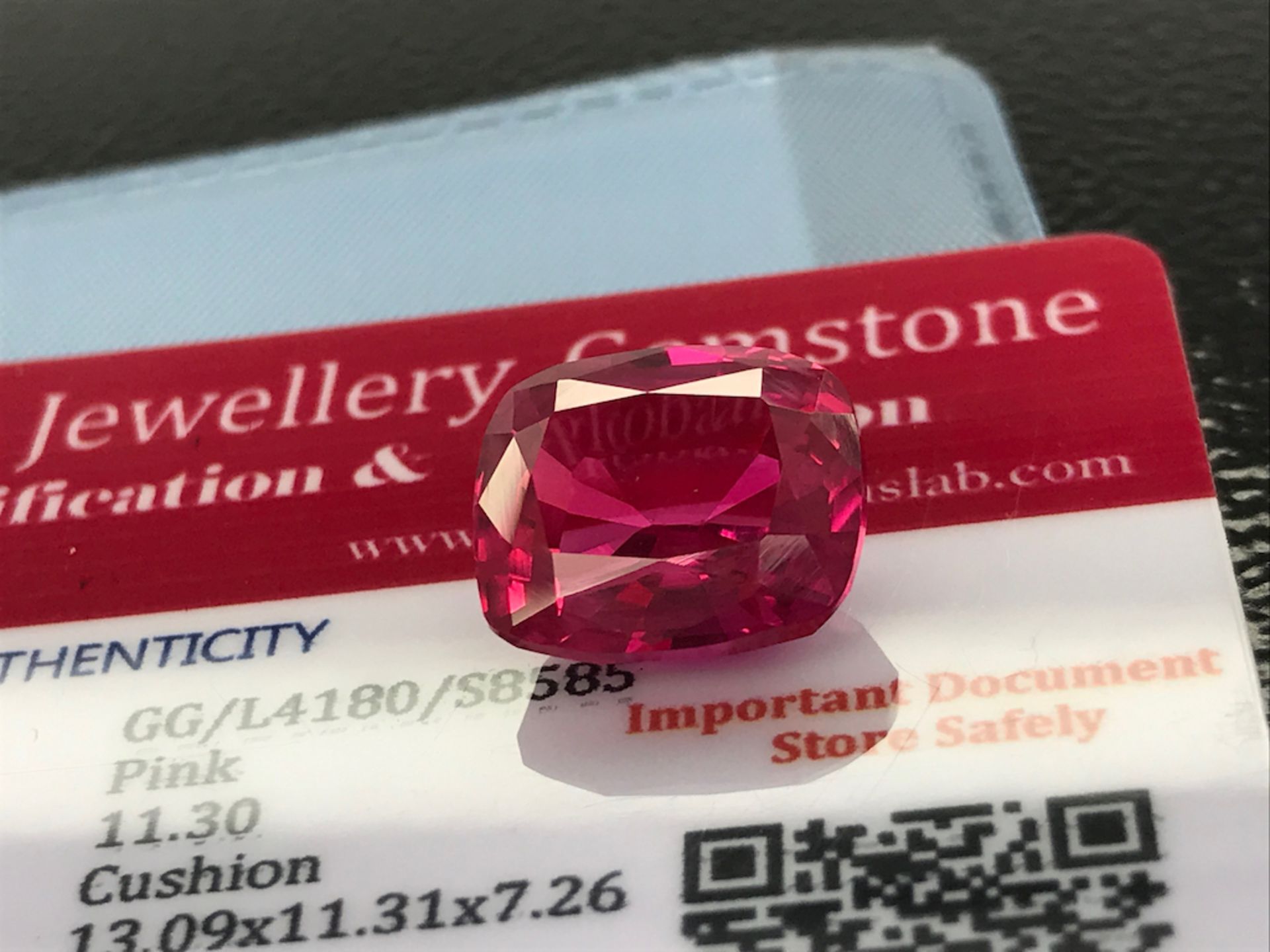PINK STONE WITH CARD MARKED SAPPHIRE