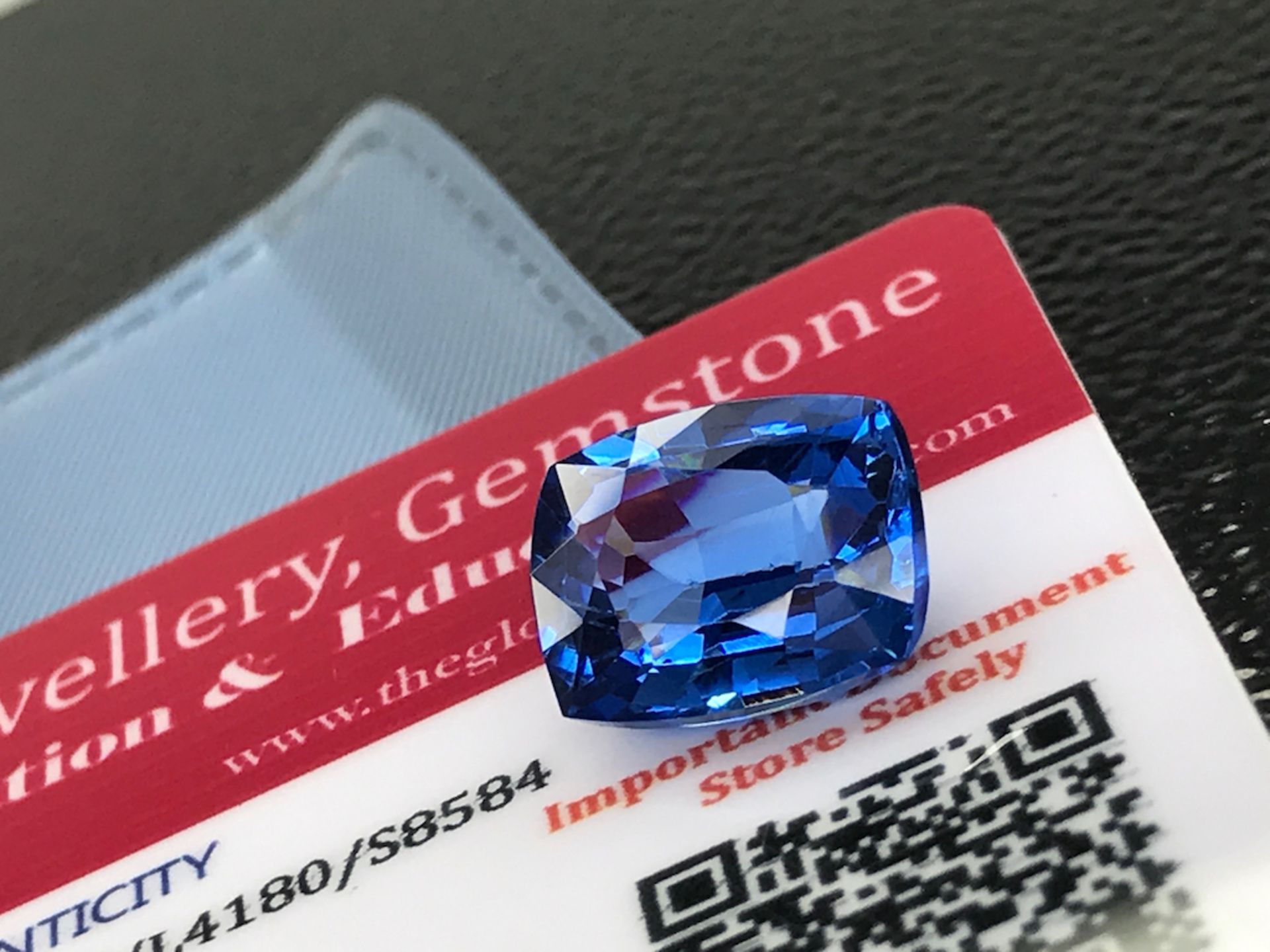 BLUE STONE WITH CARD MARKED SAPPHIRE