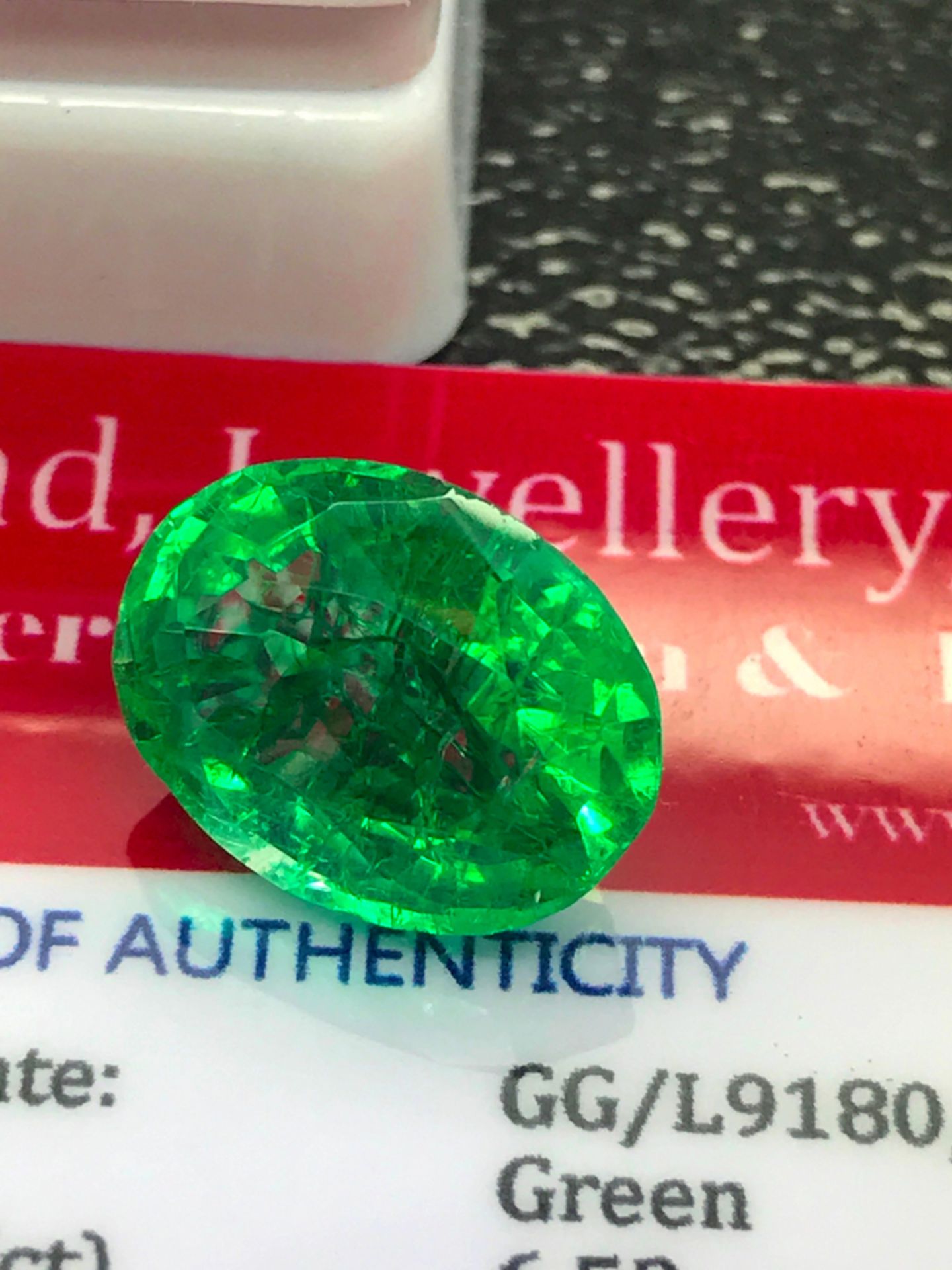 GREEN STONE WITH CARD MARKED EMERALD