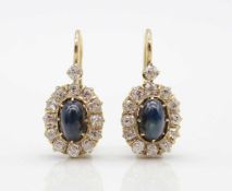 1 pair of earrings tested on 585 gold with one cabochon cut sapphire each, each approx. 1 ct and a