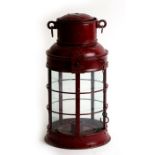 A red painted red metal ship's candle lantern, 34cms (13.25ins) high.