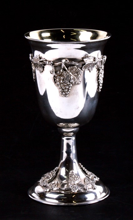 A 900 grade silver goblet with gilt interior, decorated to both base and bowl with applied grapes