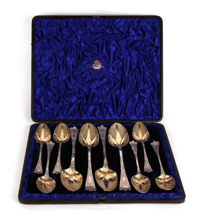 A set of silver (later chased) dessert spoons with four large serving spoons with all over