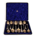 A set of silver (later chased) dessert spoons with four large serving spoons with all over