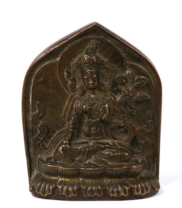 A Tibetan bronze figure of White Tara on a lotus base, with petal shape mandorla. Her head is