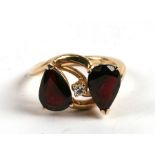 A 14ct gold, diamond & red stone ring, 4.8g. Approx. UK size M.