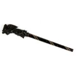 A carved tortoiseshell cane or parasol handle, in the form of an angel carrying a basket of fruit on