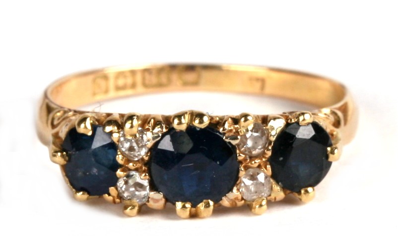 An Edwardian 18ct gold diamond and sapphire ring set with three sapphires and four diamonds,