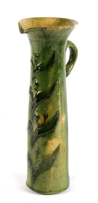 A green glazed Studio Pottery jug, 25cms (9.75ins) high.