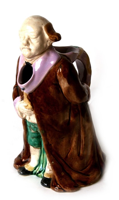 A 19th century figural majolica jug in the form of Mr Micawber, 28cms (11ins) high.