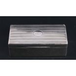 A silver two-division table top cigarette box, Birmingham 1927, 18cms (7ins) wide.